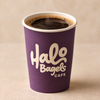 A purple paper coffee cup with the logo 'Halo Bagels CAFE' printed in white, filled with black coffee and set against a warm beige background.