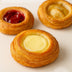 Three pastries with different fillings on a light background harlem halo bagels danishes pastries